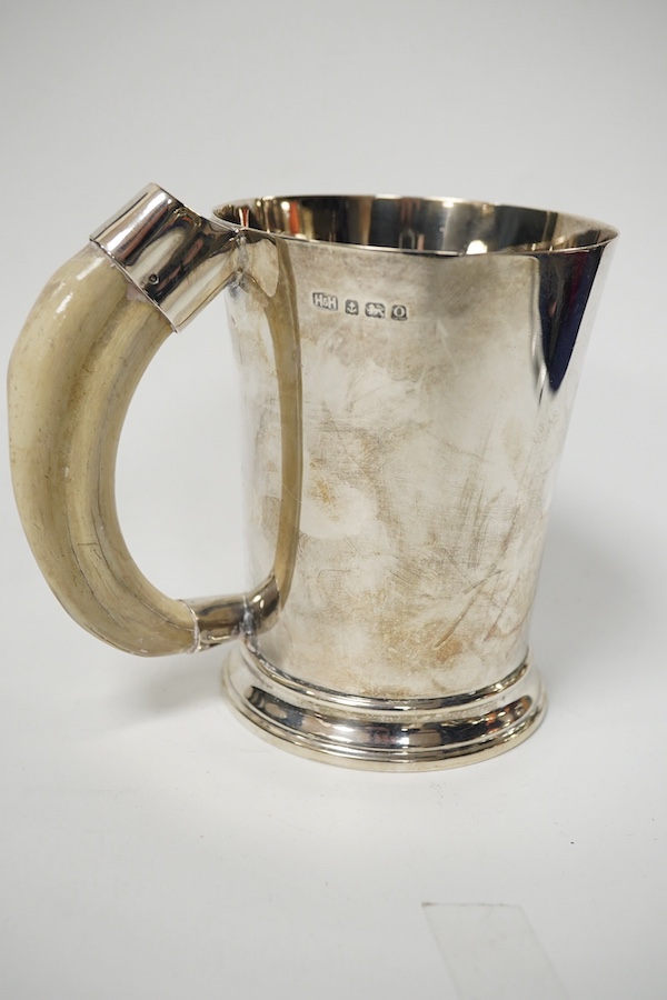 A George VI silver mug with a boar’s tusk handle, Hukin & Heath, Birmingham, 1938, height 11.8cm, gross weight 11.7oz. Condition - fair